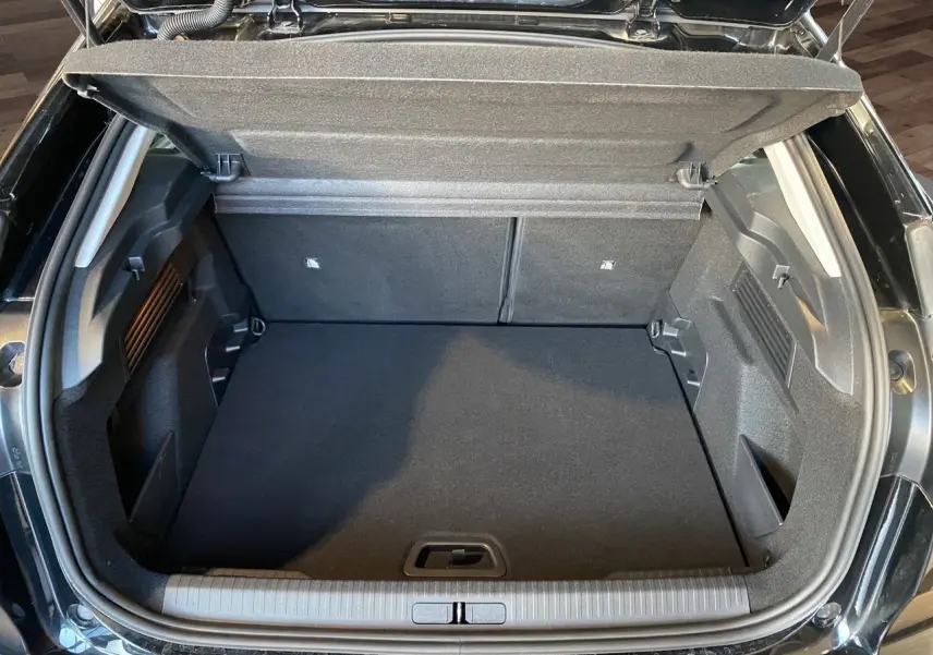 Coffre ouvert d'une Citroën C4 Noir Perla Nera 2023, vue plongeante sur l'espace de chargement vide et propre.