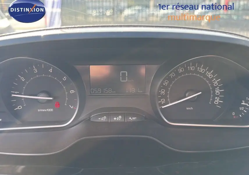 Vue rapprochée du tableau de bord numérique du Peugeot 2008 gris platinium, affichant 59158 km et vitesse à zéro.