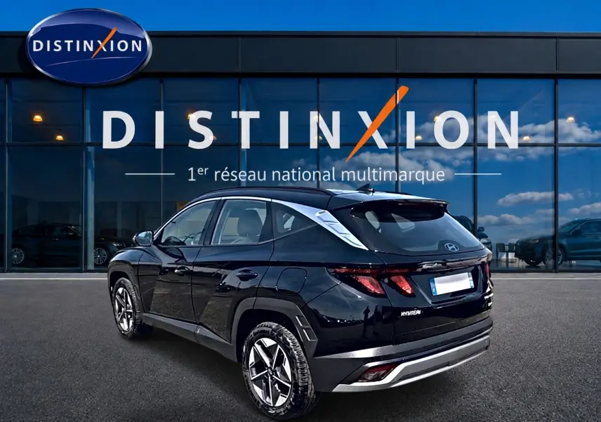Vue 3/4 arrière droite d'un Hyundai Tucson noir 2026 hybride, avec jantes alu et feux LED distinctifs.