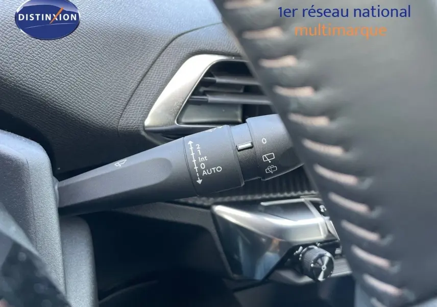 Gros plan sur la commande d'essuie-glace à gauche du volant dans l'habitacle du Peugeot 3008 2023 bleu Célèbes métal.