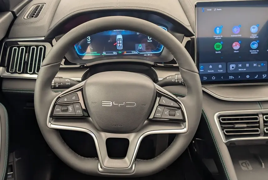 Vue intérieure centrée sur le volant noir du BYD SEAL U 2025 avec tableau de bord numérique et écran tactile 15,6 pouces.