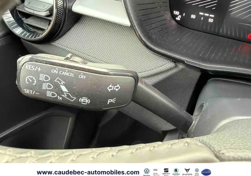 Gros plan sur la commande multifonction noire à gauche du volant dans l’habitacle d’une Skoda Fabia noire.