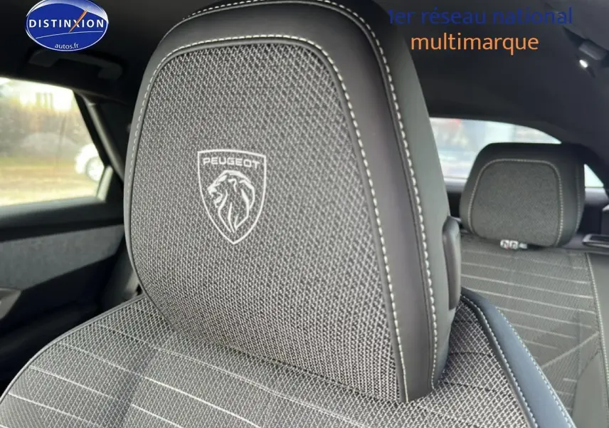 Gros plan sur l'appuie-tête avant gris titane avec logo Peugeot, intérieur tissu du Peugeot 3008 hybride 2025.