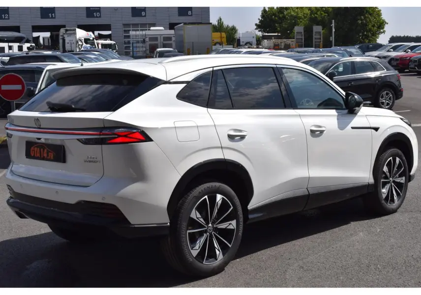 Vue 3/4 arrière droite du MG Motor EHS blanc 2026, hybride, avec feux arrière LED et jantes alliage distinctives.