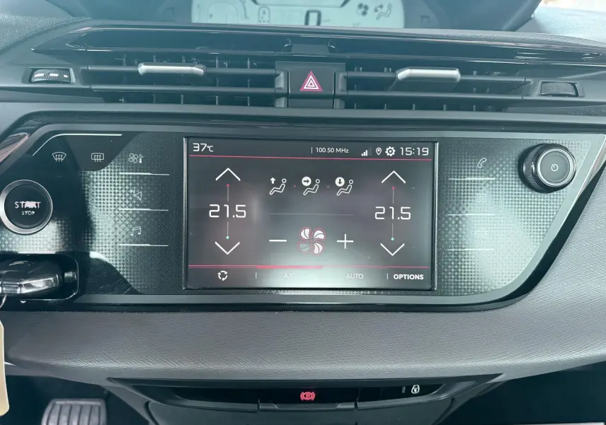 Vue rapprochée du tableau de bord noir du Citroën C4 Spacetourer 2019 avec écran tactile de climatisation affichant 21,5°C.