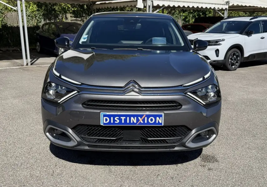 Vue avant d'une Citroën C4 PureTech 130 S&S Shine gris foncé avec feux LED et calandre distinctive.