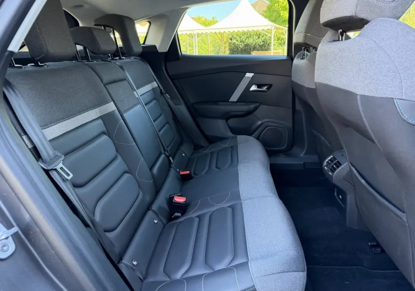 Vue intérieure côté droit sur la banquette arrière bi-matière gris foncé et noir de la Citroën C4 PureTech 130 Shine 2022.