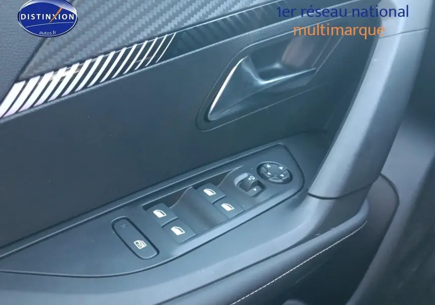 Détail de la commande des vitres électriques côté conducteur dans l'habitacle gris du Peugeot 2008 1.2 100 allure 2025.