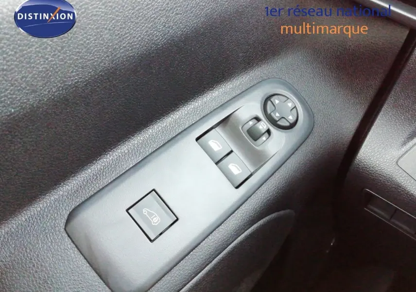 Gros plan sur les commandes de lève-vitres et réglage des rétroviseurs côté conducteur du Peugeot Partner blanc Kaolin.