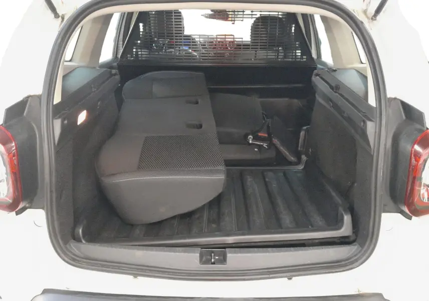 Vue intérieure du tableau de bord et volant noir du Dacia Duster 2021 avec levier de vitesse manuel et commandes centrales visibles.