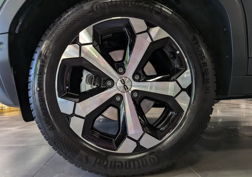 Gros plan sur la jante bi-ton noire et argentée d’un Dacia Duster Vert Cèdre, avec pneu Continental visible.