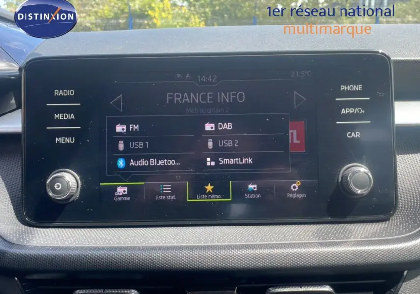 Écran tactile central de la Skoda Fabia blanc candy 2022 affichant les options radio et connectivité Bluetooth.