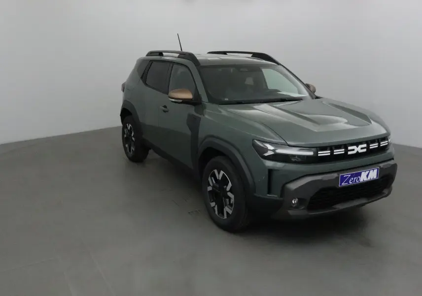 Dacia Duster 2025 kaki lichen en 3/4 avant droit avec jantes noires et coques de rétroviseur bronze.