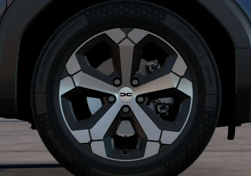 Gros plan sur la roue avant droite du Dacia Bigster bleu indigo, mettant en valeur la jante alliage au design moderne.