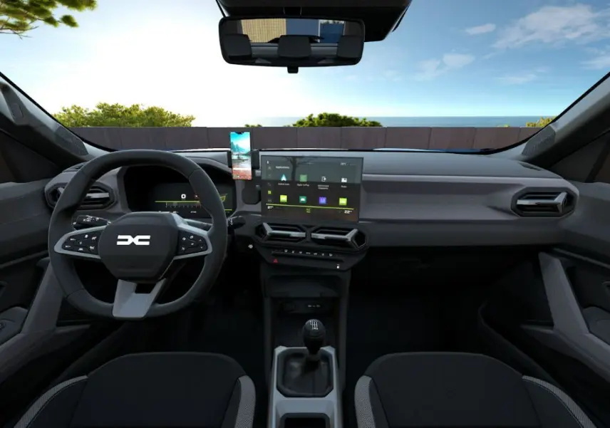 Vue intérieure avant du Dacia Bigster 2026 avec tableau de bord moderne, écran tactile central et volant multifonction noir.