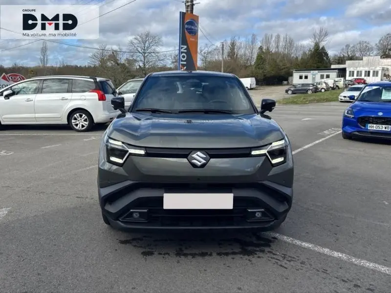 Vue de face du Suzuki Vitara 2026 électrique en vert Land Breeze avec toit noir, mettant en valeur ses phares LED distinctifs.