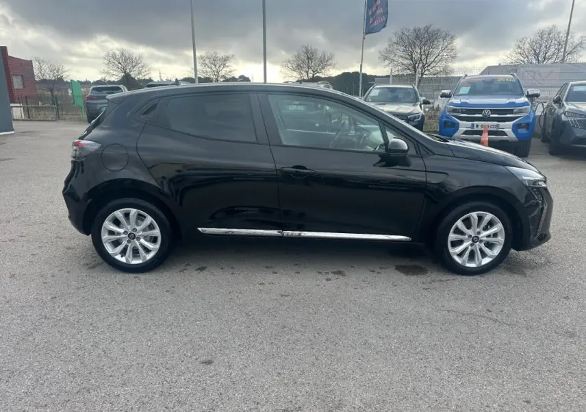 Profil droit d'une Renault Clio noire 2025 avec vitres surteintées et jantes alliage visibles en extérieur.
