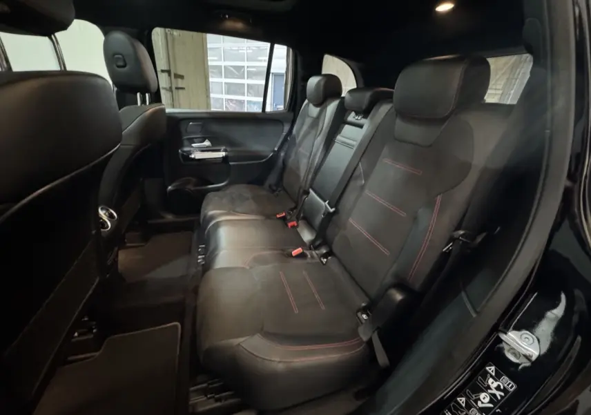 Vue intérieure côté droit des sièges arrière noirs avec surpiqûres rouges du Mercedes GLB 200 d AMG Line 2020.