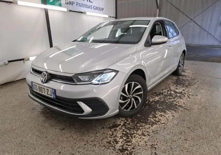 Vue 3/4 avant droite d'une Volkswagen Polo gris clair 2023 avec phares LED et jantes alliage bicolores.