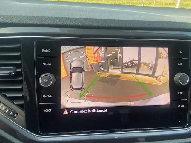 Écran central du Volkswagen T-Roc gris Indium montrant la caméra de recul avec guidage de trajectoire en vert et rouge.