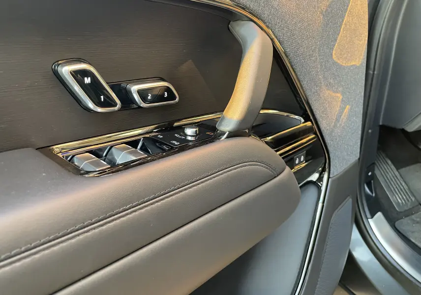 Détail de la porte avant gauche du Range Rover Sport P440 HSE R-Dynamic 2023 en Carpathian Grey, avec commandes mémoire sièges et finition noire brillante.