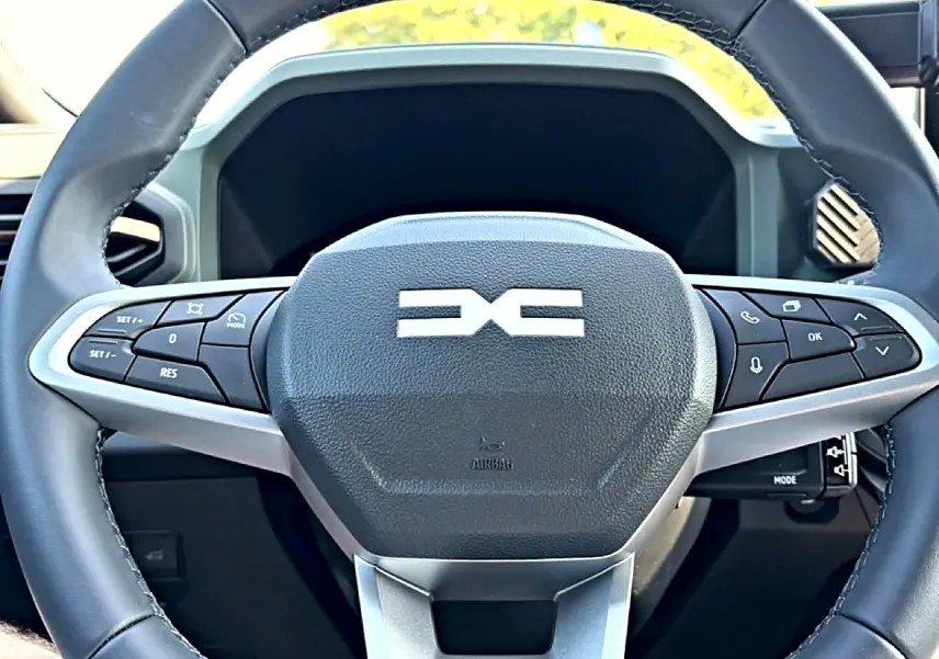 Gros plan sur le volant multifonction noir et gris du Dacia Bigster 2026 avec logo central distinctif.