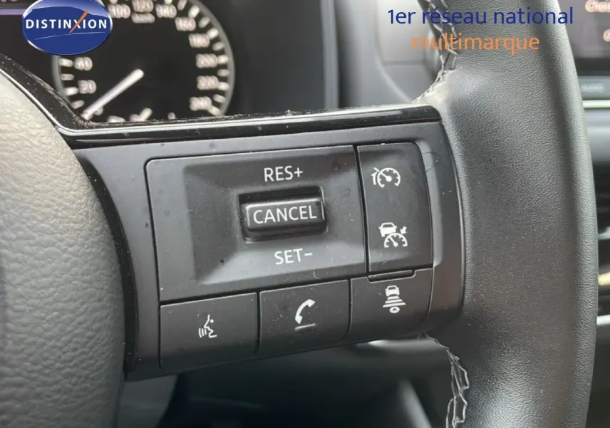 Gros plan sur les commandes au volant du Nissan Qashqai 2023, finition Business Edition, volant cuir noir.