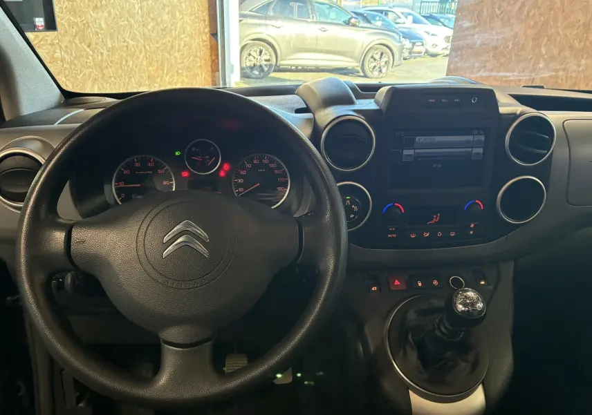Vue intérieure du tableau de bord et volant noir d'un Citroën Berlingo Multispace 2017 avec boîte manuelle.