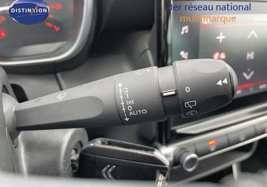 Gros plan sur la commande d'essuie-glace à gauche du volant dans l'habitacle d'une Citroën C3 Aircross noir perle métal 2023.