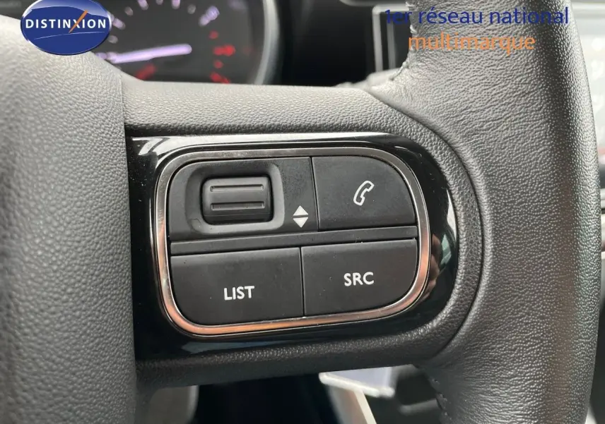 Gros plan sur les commandes audio au volant du Citroën C3 Aircross noir perle métal, version 2023, finition Shine.