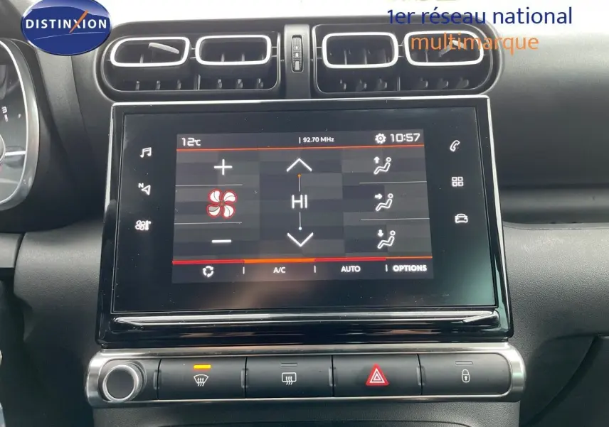 Écran tactile central de la Citroën C3 Aircross 2023 affichant les réglages de climatisation, entouré d'aérateurs noirs.