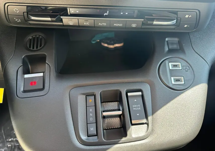 Vue rapprochée de la console centrale grise du Citroën Berlingo 2026 avec commandes clim et boîte auto en Kiama Blue.
