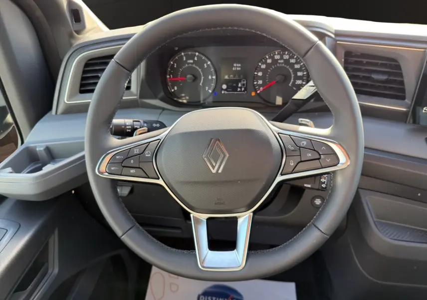 Vue rapprochée du volant noir du Renault Master 2026 avec tableau de bord et commandes intégrées visibles.