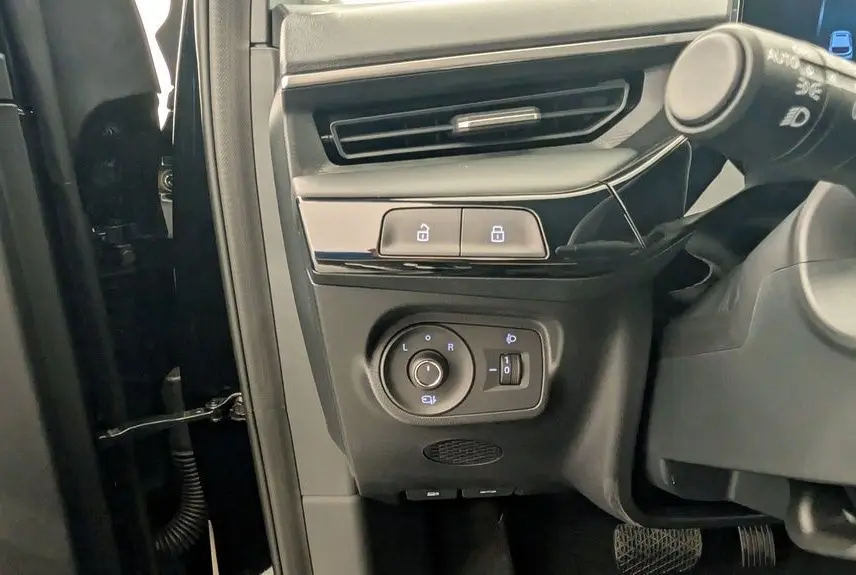 Détail des commandes côté gauche du tableau de bord d’un MG3 Pebble Black 2026, avec boutons de verrouillage et réglage des rétroviseurs.