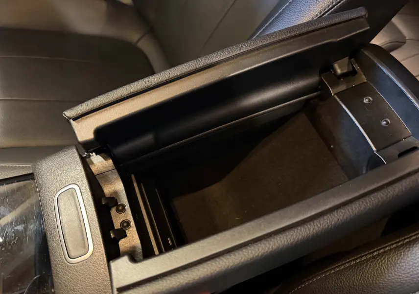 Vue rapprochée de l'accoudoir central noir ouvert de la Mercedes Classe A 2022 avec intérieur en similicuir noir.