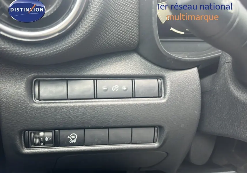 Détail des commandes de réglage d’éclairage et tableau de bord noir du Nissan Juke rouge Fuji Metal 2024.