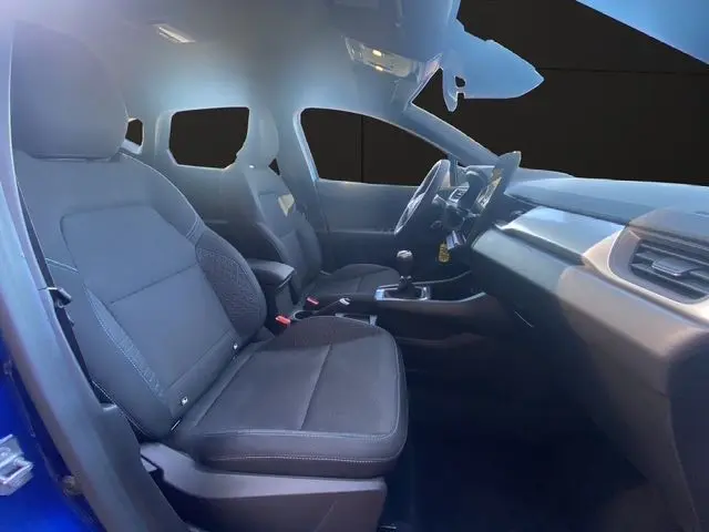 Intérieur avant du Renault Captur TCE 90 Evolution 2024, sièges tissu gris et volant en tissu côté gauche.