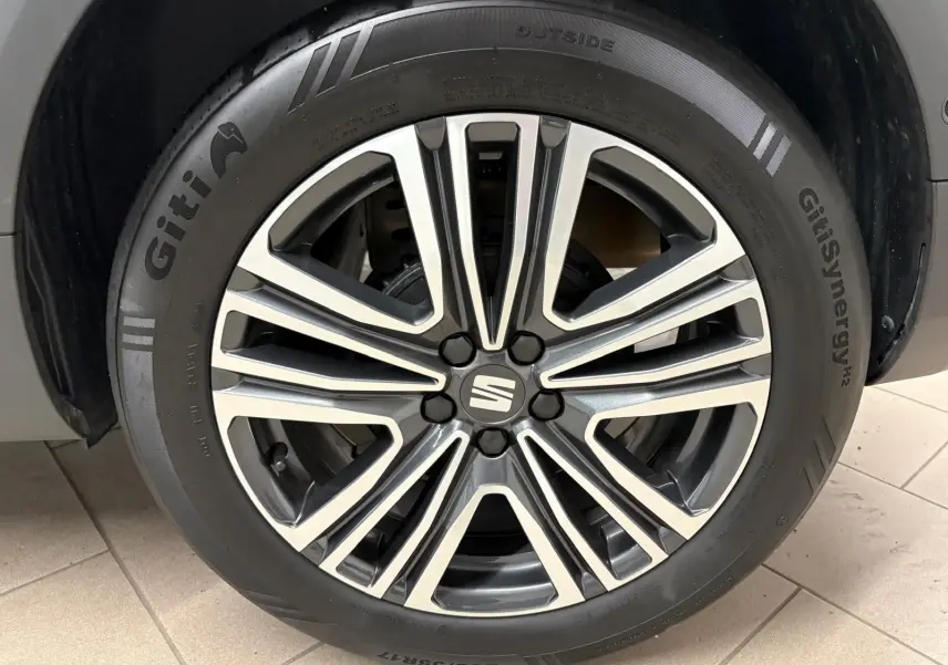 Gros plan sur la jante alliage argentée et noire du SEAT Arona 2025, mettant en valeur le logo central de la marque.