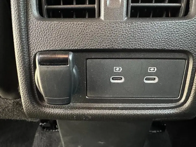 Prise 12V et deux ports USB-C arrière sur console centrale noire du Renault Symbioz rouge Flamme 2025.