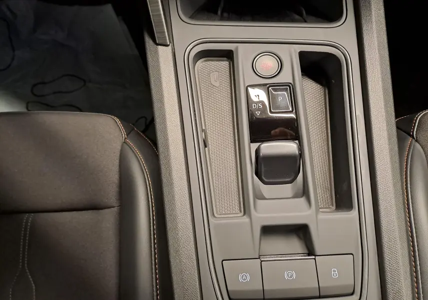 Vue plongeante sur la console centrale de la CUPRA Leon 2023 avec levier de vitesse automatique et bouton start/stop.