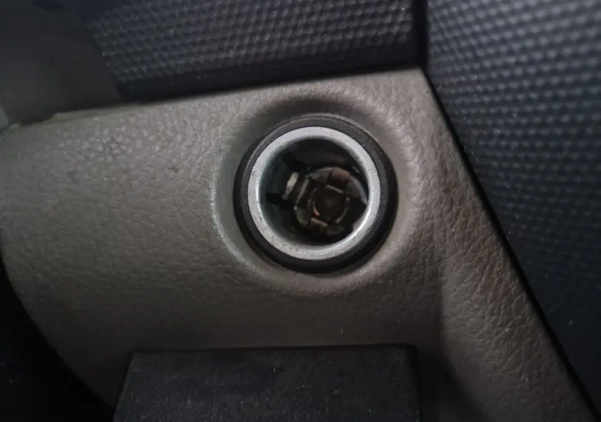 Détail du contacteur d'allumage sur le tableau de bord intérieur du Nissan Cabstar blanc, version 2010.