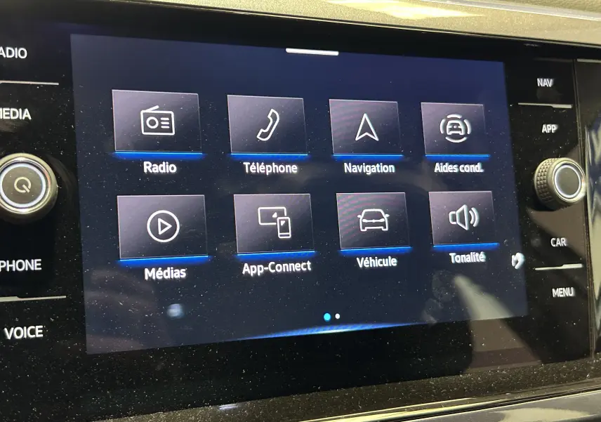 Écran tactile central du Volkswagen Taigo TSI 110 DSG7 Style 2022 affichant les options radio, téléphone, navigation et aides à la conduite.