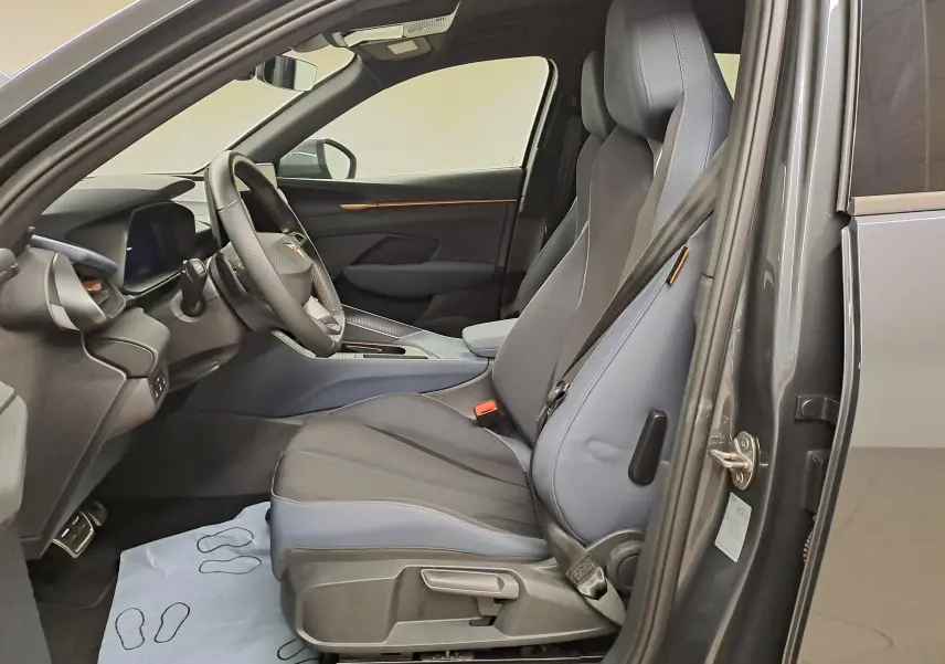 Vue intérieure côté conducteur de la CUPRA TERRAMAR 2025 en Gris Timanfaya, sièges sport et tableau de bord moderne.