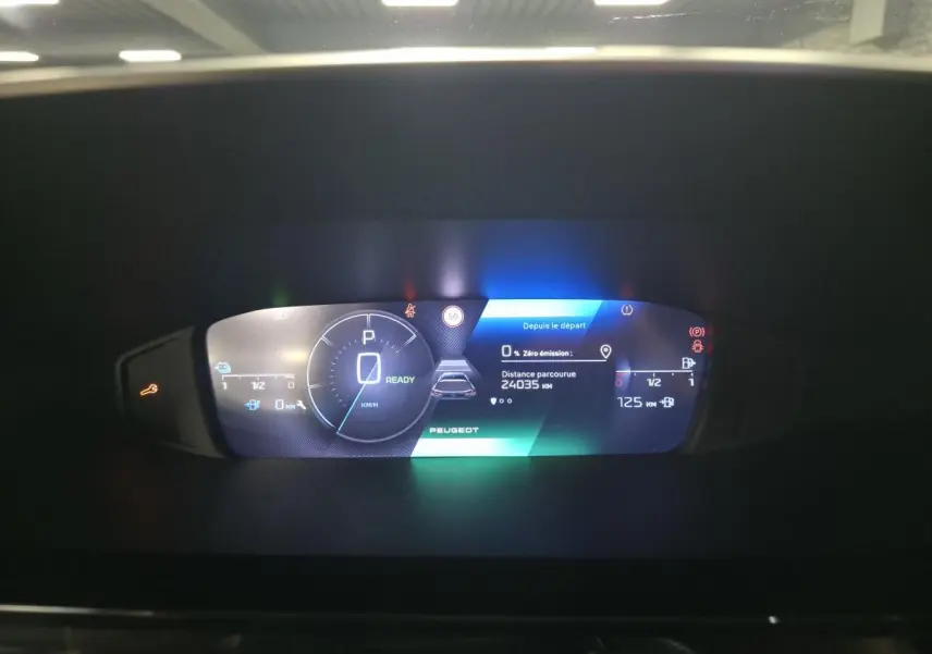Affichage numérique du tableau de bord Peugeot 308 SW hybride rechargeable, montrant la vitesse à 0 km/h et l'autonomie restante.