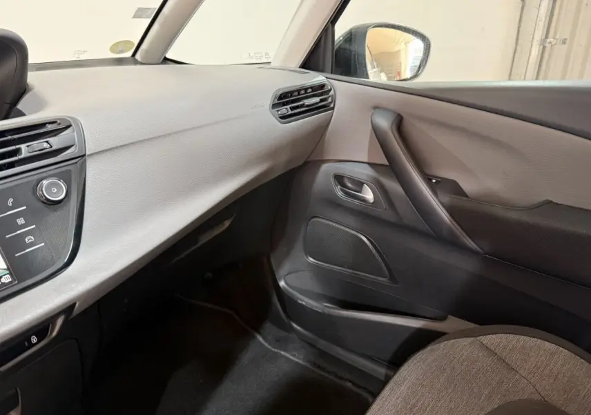 Vue intérieure côté passager du tableau de bord et de la porte d’une Citroën Grand C4 Spacetourer blanc, finition Business.