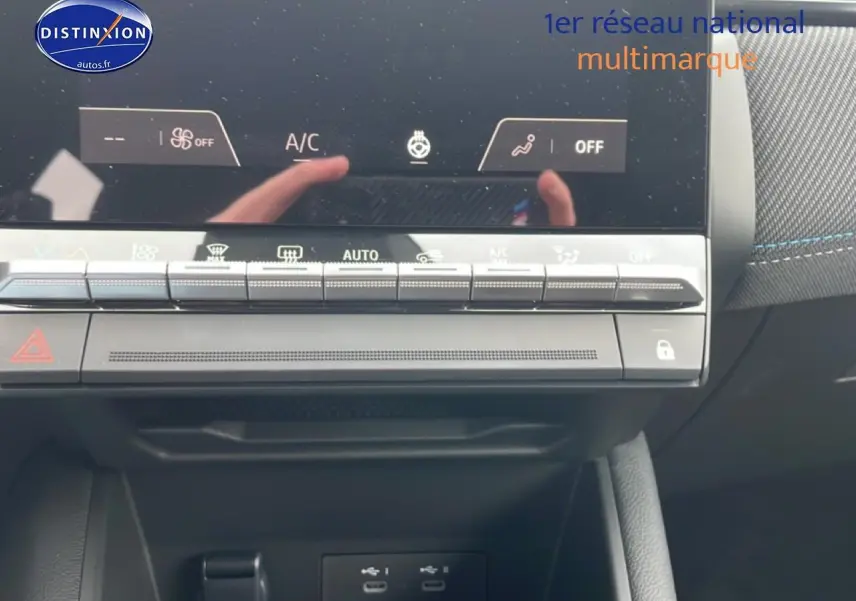 Gros plan sur la console centrale tactile et les commandes climatisation du Renault Captur gris cassiopée 2025.