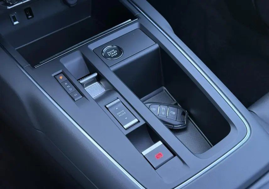 Gros plan sur la console centrale noire du Citroën C5 Aircross 2025 avec bouton start, levier de vitesses et clé posée.