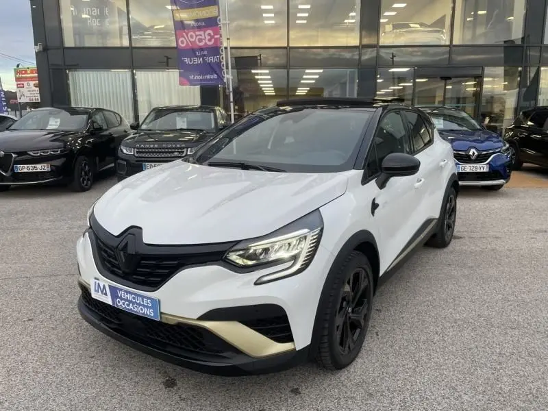 Renault Captur 1.6 E-Tech hybride blanc nacré, vue 3/4 avant droit, toit noir et jantes noires, 2023.