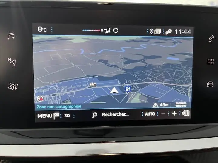 Écran tactile du système de navigation de la Peugeot 208 gris Artense, affichant une carte en mode 3D.