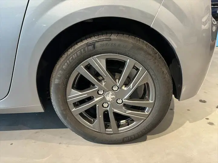 Gros plan sur la roue avant gauche gris Artense métal d'une Peugeot 208 1.2 100 CH S&S STYLE avec jante alliage moderne.